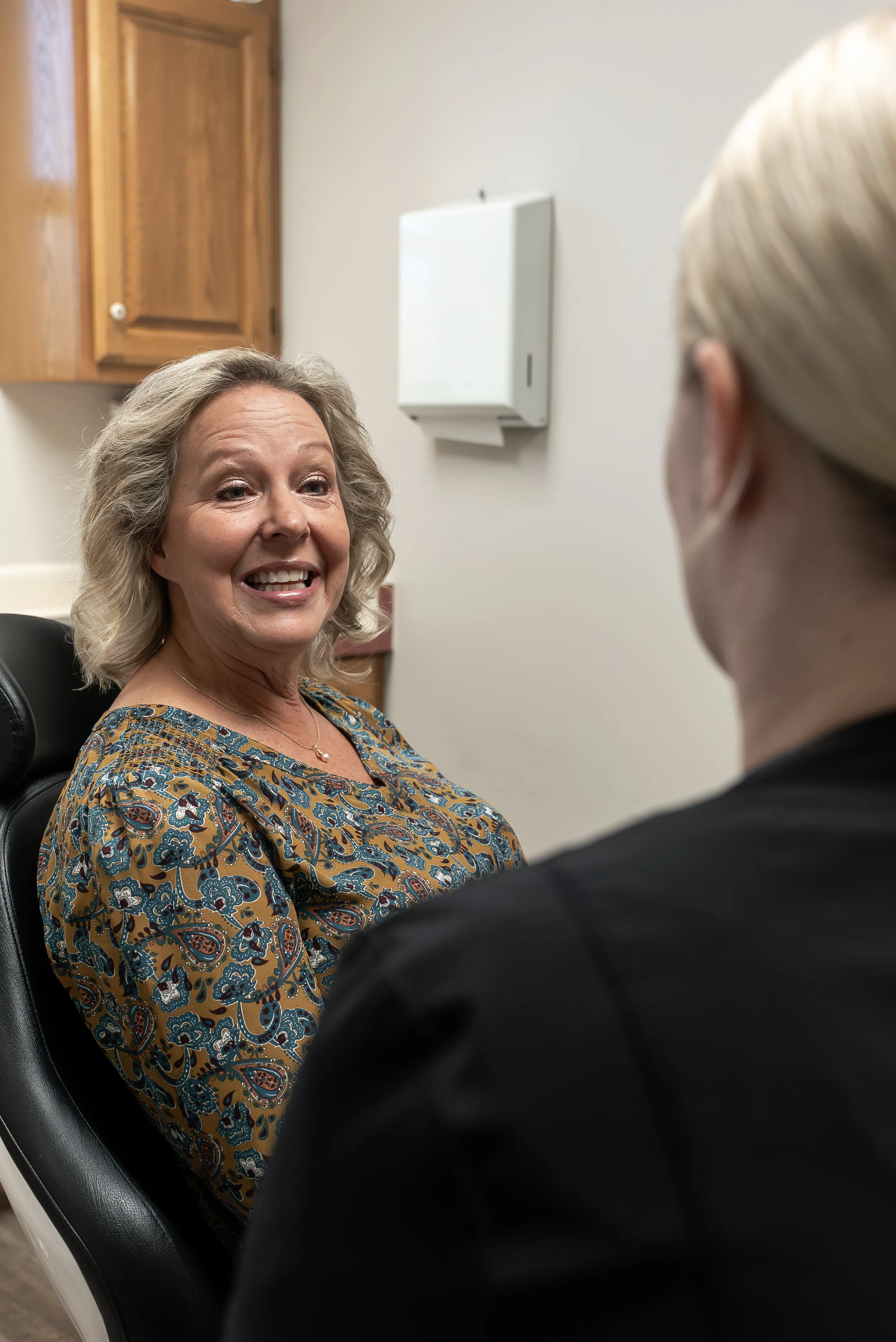 Dentist performing a tooth filling procedure on a patient.